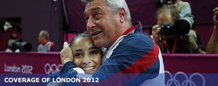Alexandra Raisman of the U.S. embraces coach Mihai Brestyan after the result of the enquiry was announced in the women's gymnastics balance beam final. (REUTERS/Brian Snyder)