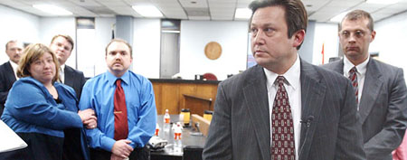 Eric and Cassandra Peoples (left) listen as their attorney discussed their 2004 judgment. (ABC News/AP Photo)