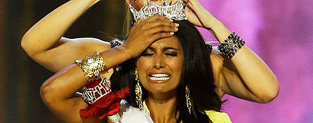 Miss New York Nina Davuluri, front, is crowned as Miss America 2014 by Miss America 2013 Mallory Hagan, Sunday, Sept. 15, 2013, in Atlantic City, N.J. (AP Photo/Mel Evans)