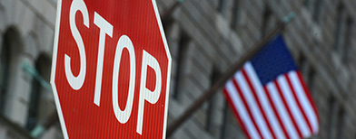 Stop sign in front of US flag (PA)