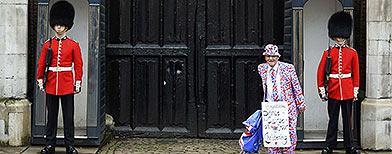 A royal fan bedecked in Union Jacks poses outside St James's Palace (REUTERS))