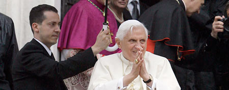 In a file photo, the pope's butler Paolo Gabriele (left) holds an umbrella for Pope Benedict XVI on May 17, 2008, in Savona, near Genoa, Italy. (AP Photo/Luca Bruno)
