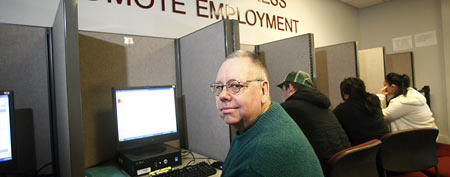 David Brotherton and other job seekers look for work at WorkSource Oregon, in Salem, Oregon. (AP Photo/Rick Bowmer)