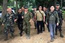 Gun-toting Duterte in surprise visit near warzone