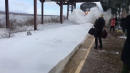 The Polar Express: Amtrak Train Kicks Up Waves of Snow as It Pulls into Station