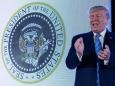 Trump speaks in front of fake presidential seal mysteriously manipulated to feature Russian eagles and golf clubs