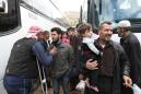 Tearful Syrians leave rebel enclave in largest evacuation yet