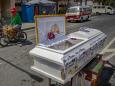 Open coffins are left on roads to remind people to stay inside while soldiers shoot disinfectant from water cannons. Here's what lockdown for 57 million people in the Philippines looks like.