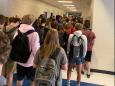A Georgia high school that suspended students for posting pictures of crowded hallways now has 9 reported cases of coronavirus