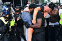 A picture and its story: Black personal trainer carries suspected far-right protester to safety