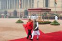 Maskless Merkel braves severe Delhi smog