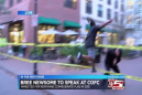 Activist heroically flies over barricade to seize Confederate flag