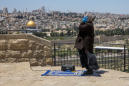 Muslims in Jerusalem pray outdoors amid virus lockdown