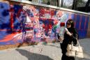 Iran unveils new anti-US murals at former embassy