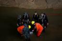 Thai lucky 13 found, but still stuck as divers draw up cave rescue plans