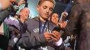 This Kid Looking At His Phone Is The Super Bowl's Best Meme