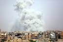 Dozens reported dead in US-led strikes as battle nears Raqa heart
