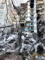 Russia: 4 die in building collapse; searchers race weather