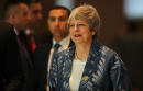 British PM May signals she is ready to fight on