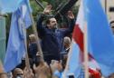 Hariri says resignation on hold, pledges to stay in Lebanon