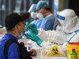 China shuts schools and cancels flights as Beijing reports an 'extremely grave' surge in new coronavirus cases
