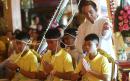 Rescued Thai football boys pray at Buddhist temple as they begin first day back home