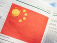China demands an apology from a newspaper for a satirical cartoon of a Chinese flag with coronavirus particles