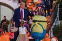 Donald and Melania Trump place candy on top of child's Minion Halloween costume, video goes viral