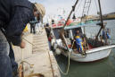 AP PHOTOS: Virus outbreak hurts Italian fishermen's business