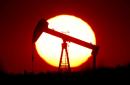 Oil rises as storm closes U.S. production, inventories drop
